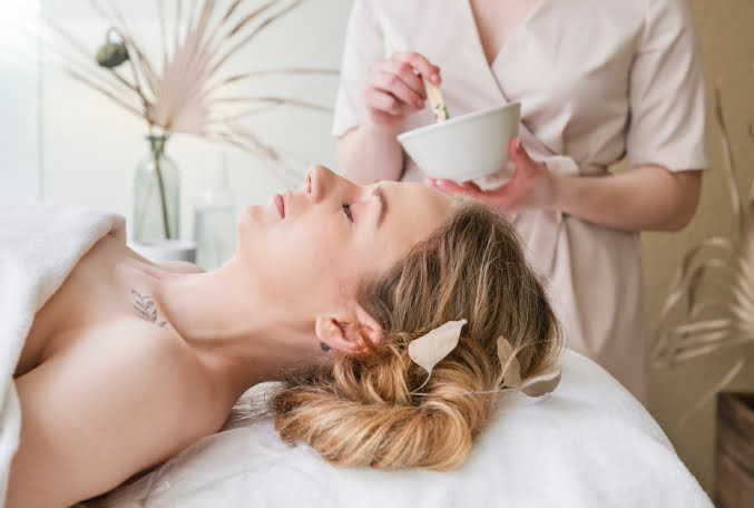 Elderly woman exercising near wall mounted ladder with instructor 1